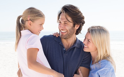 Smiling family on the beach.